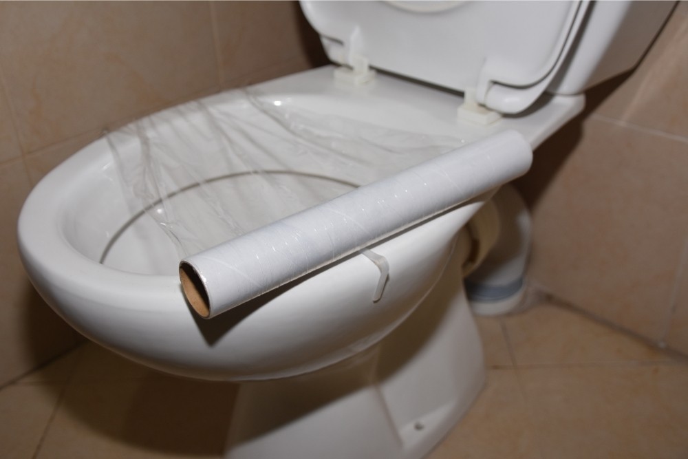 how to unclog a toilet with saran wrap